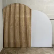 The wood slat arch backdrop with the white fin panel beside it