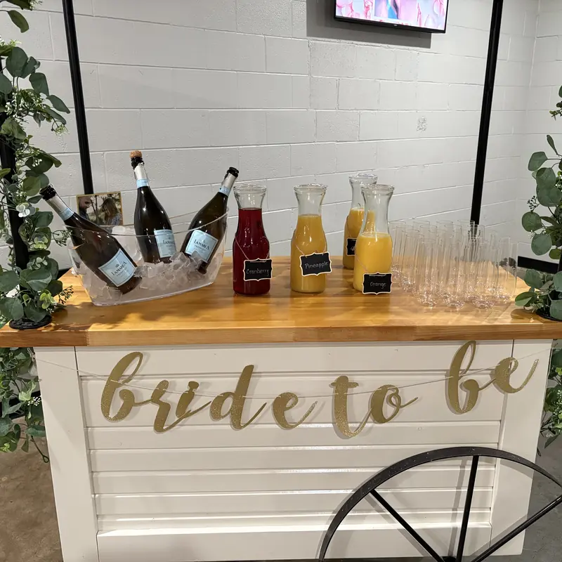 The bar cart set with champagne and juice for a bridal shower