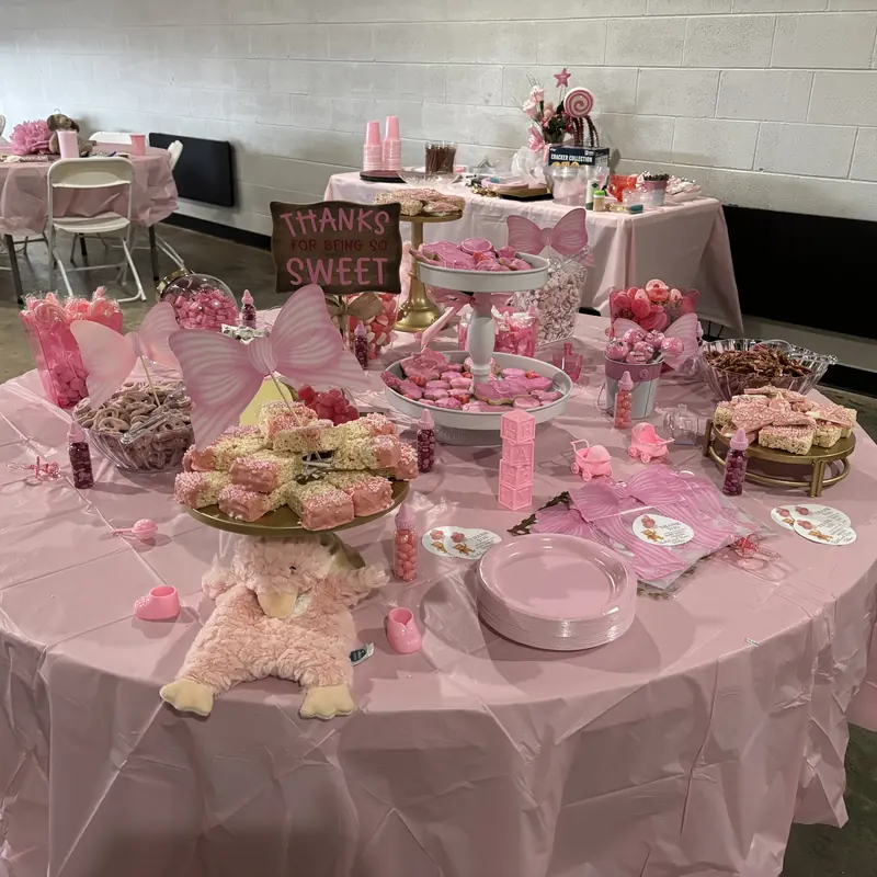 A pink candy table with a Thanks for the Sweet sign