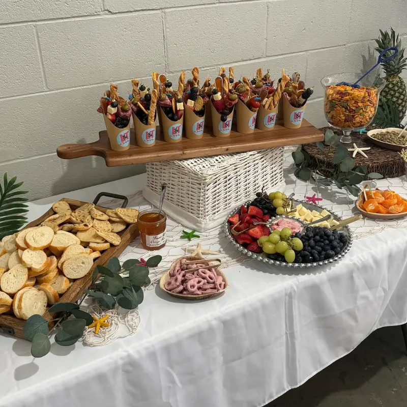 A grazing table with charcuterie cones, fruit and bread